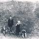 Four children playing in bomb crater in field by Harmer Hill Village Hall - JN